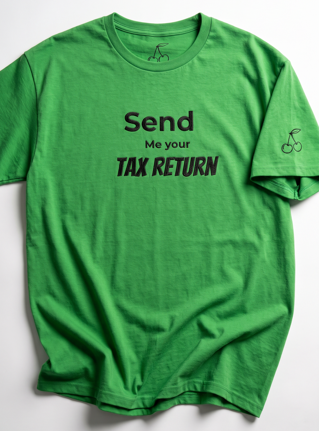 A bright green short-sleeve t-shirt with black printed text reading 'Send Me your TAX RETURN' on the front, laid flat against a light gray background.