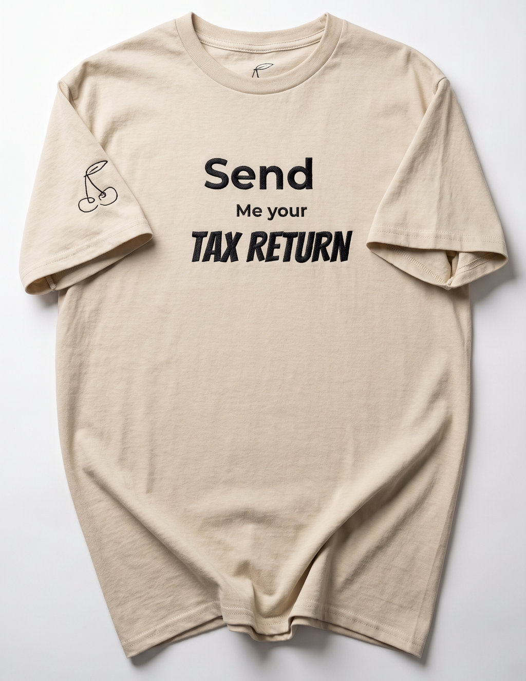 A beige crewneck t-shirt with black text reading 'Send Me your TAX RETURN' on the front, laid flat against a light gray background.
