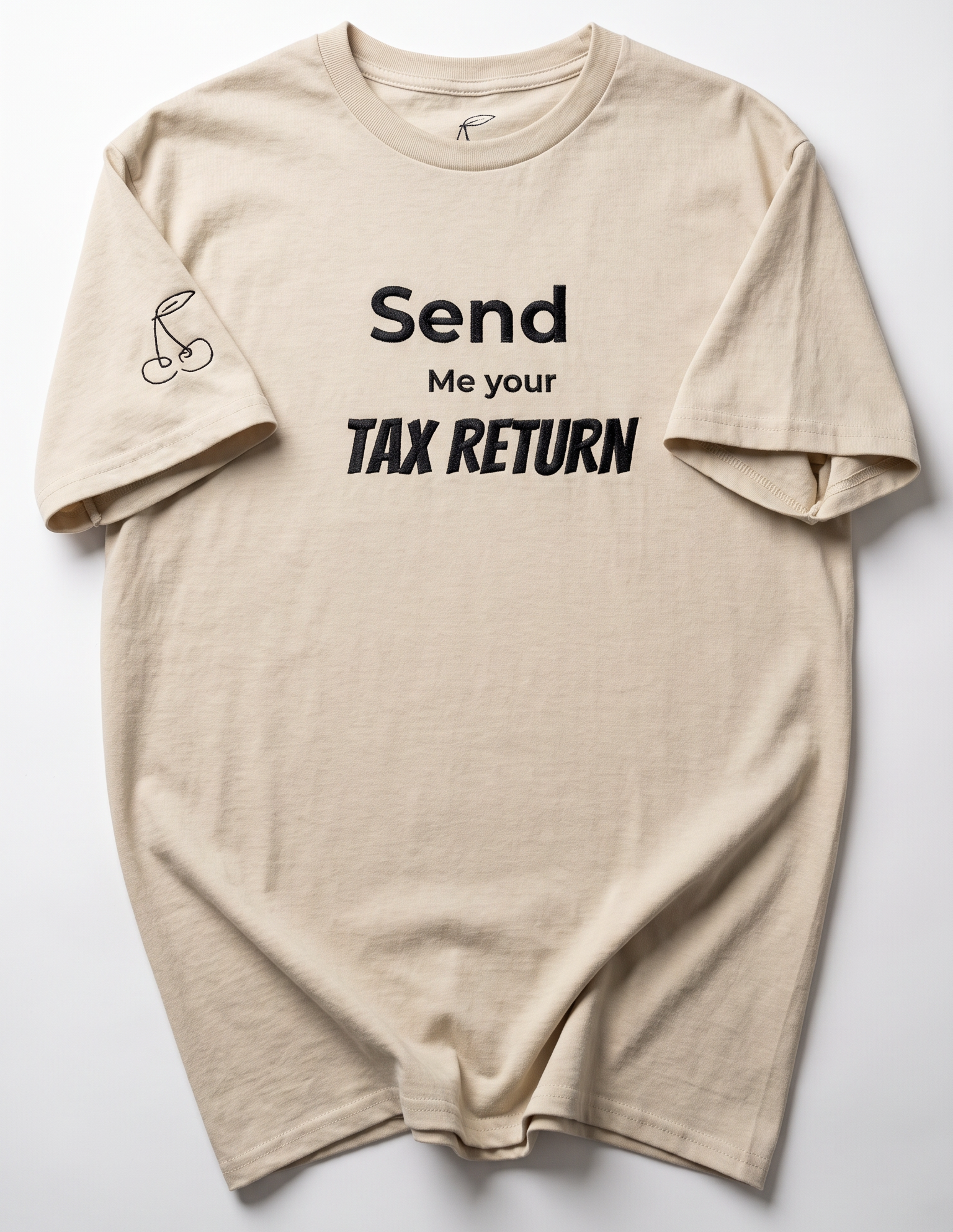 A beige crewneck t-shirt with black text reading 'Send Me your TAX RETURN' on the front, laid flat against a light gray background.