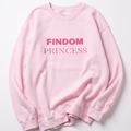 A light pink crewneck sweatshirt with 'FINDOM PRINCESS' printed in pink across the chest, laid flat on a light gray background.