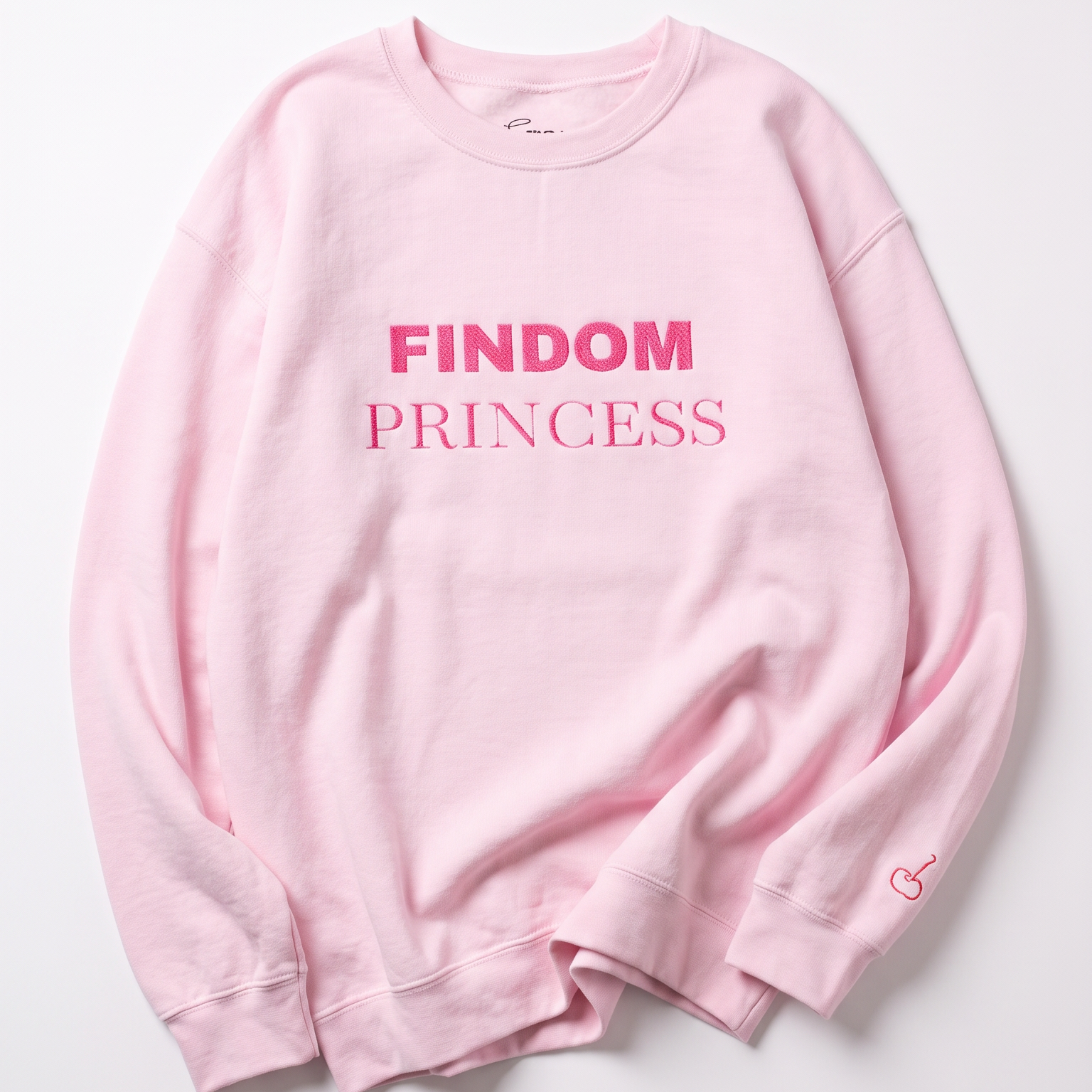 A light pink crewneck sweatshirt with 'FINDOM PRINCESS' printed in pink across the chest, laid flat on a light gray background.
